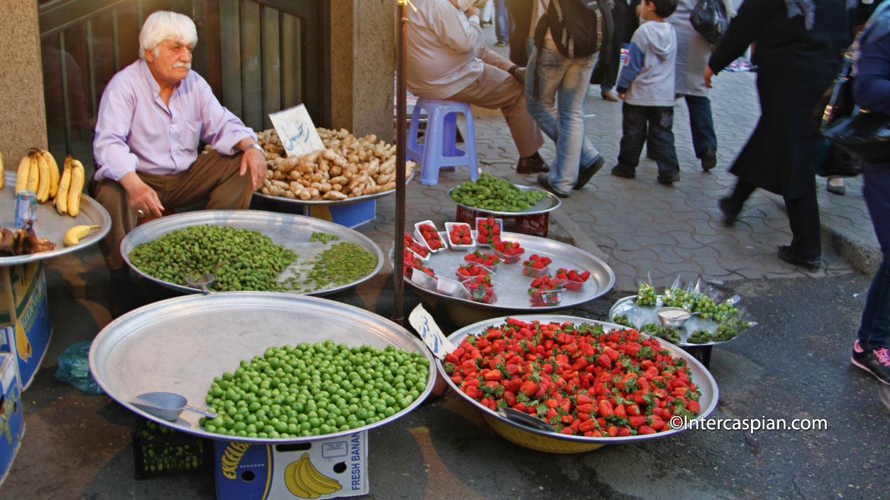 A sidewalk vendor with spring fruits